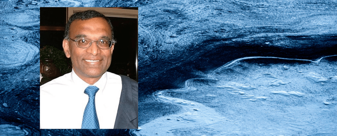 Professor Alok Bhargava's headshot on a background of icy ocean water