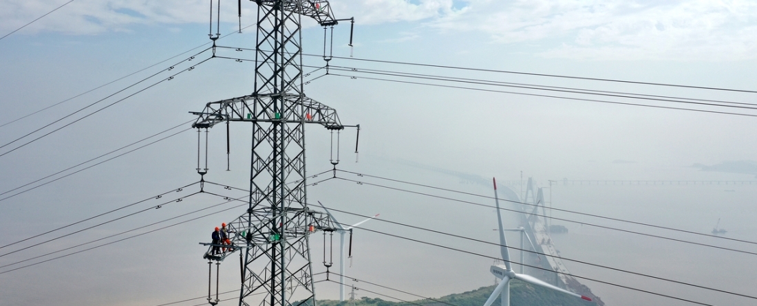 picture of electricity transmission lines and a windmill in a China